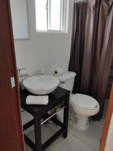 a bathroom with a sink and a toilet at Suites Casa Blanca Metepec in Toluca