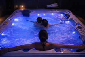 a group of people swimming in a swimming pool at Domek A - domki w górach z prywatnym SPA - 4 seasons lodges Ustroń in Ustroń +43 photos