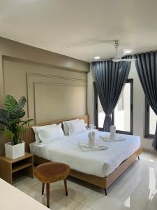 a bedroom with a large bed with two dishes on it at V Club in Bhuj +102 photos