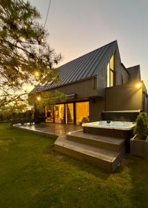 a house with a swimming pool in front of it at VILLA PIKADI BY THE Baltic Sea in Palanga