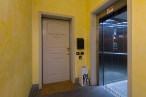 a white door in a hallway with a sign on it at Bergamo Sottosopra in Bergamo
