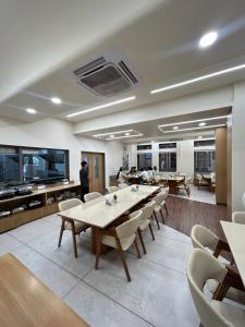 a conference room with a long table and chairs at V Club in Bhuj