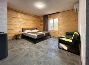 a bedroom with a bed and a chair in a room at NorDar in Garni +90 photos