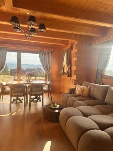a living room with a couch and a table at Little House in Ząb