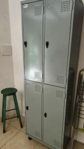 two metal lockers in a room with a stool at Pedramarca - Ferrugem in Garopaba +25 photos