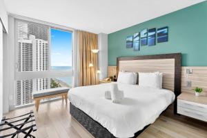 a bedroom with a large bed and a large window at Marenas Resort Beachfront Condo with Direct Access in Sunny Isles Beach
