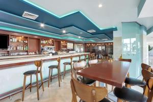 a bar with a wooden table and chairs at Marenas Resort Beachfront Condo with Direct Access in Sunny Isles Beach