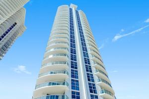 a tall white building with blue sky in the background at Marenas Resort Beachfront Condo with Direct Access in Sunny Isles Beach +20 photos