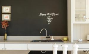 a kitchen with a sink and a black wall at Vakantiewoning Kastijd Kortessem - Haspengouw in Kortessem +8 photos