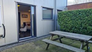 a wooden bench sitting in front of a building at Landkamer in Bolsward