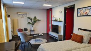 a living room with a couch and a tv at Landkamer in Bolsward