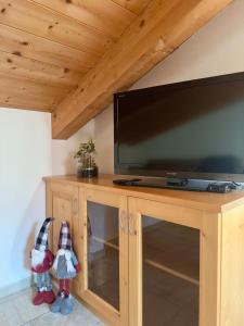 a wooden entertainment center with a flat screen tv at Ca' de Mario in Sondalo