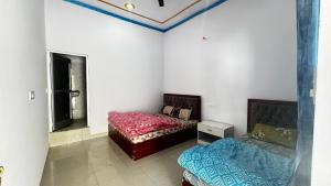 a bedroom with two beds in a room at Hotel Himalayan View Kedarnath in Phata +11 photos