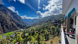 a view of a valley from the balcony of a building at Hotel Himalayan View Kedarnath in Phata