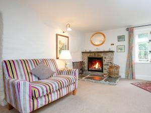 a living room with a couch and a fireplace at Tuckenhay, 3 Castle Cottage - Fcm in Ashsprington +38 photos