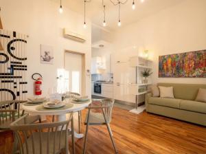 a kitchen and living room with a table and chairs at Terrazza San Martino Private Terrace Stay in Monopoli