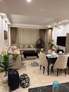 a living room with a couch and a table at Oyster bey Beach Suites J1-04 in Marsa Alam