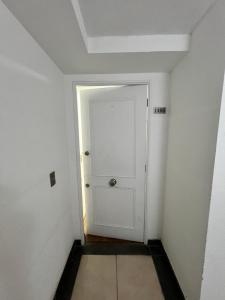 a white door in a room with a white wall at Mar & Costa Valparaíso in Valparaíso