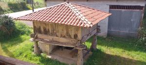 a bird house with a roof on top of it at Apartamentos Rurales Pernús in Colunga +2 photos