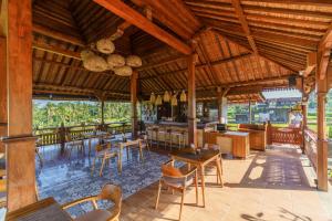 a pavilion with tables and chairs in a restaurant at Cahya Restu Ubud Villa in Ubud