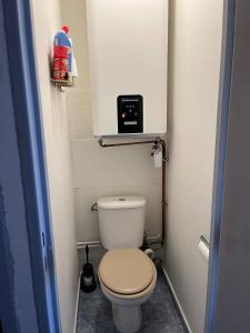 a small bathroom with a toilet with a clock on the wall at Appartement Cap D'Agde in Cap d'Agde +6 photos