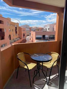 a table and chairs on a balcony with a view at Appartement Cap D'Agde in Cap d'Agde