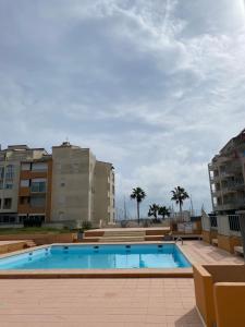 a large swimming pool with buildings in the background at Appartement Cap D'Agde in Cap d'Agde