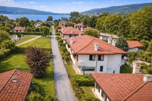 a village with red roofs and a lake at LaBohème Lake Maggiore Retreat with Private Beach in Dormelletto