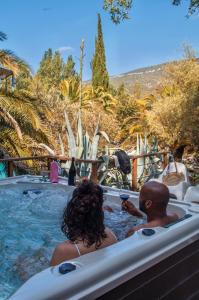 a man and a woman in a jacuzzi tub at Camping la Peiriere - Évasion en Dôme in Tuchan +26 photos