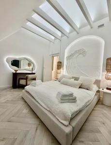 a white bedroom with a large bed and a tv at VILLA PIKADI BY THE Baltic Sea in Palanga +98 photos
