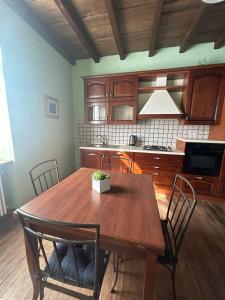 a kitchen with a wooden table and chairs at Casa La Torretta in Ceva