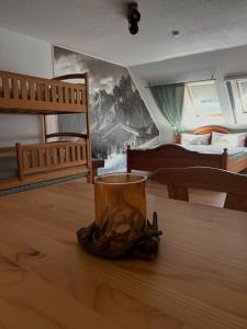 a bedroom with two bunk beds and a cup on a table at Ferienzimmer Teiselsmühle Gehren Heideblick in Heideblick +18 photos