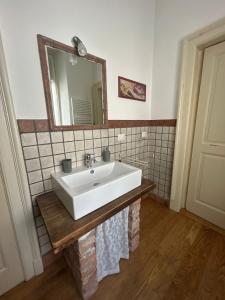 a bathroom with a white sink and a mirror at Casa La Torretta in Ceva