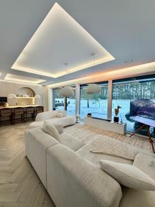 a living room with a large couch and a television at VILLA PIKADI BY THE Baltic Sea in Palanga