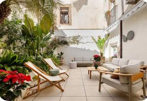 a patio with couches and a lot of plants at xenia apartments & suite in Syracuse