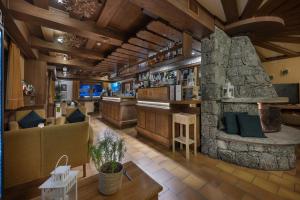a bar in a restaurant with a stone fireplace at Hotel Cardo in Valdidentro