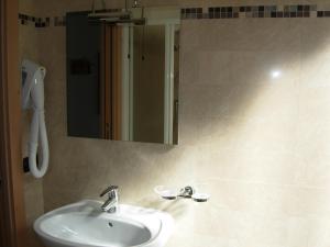 a bathroom with a sink and a mirror at B&B Ledro AFFITTACAMERE in Mezzolago