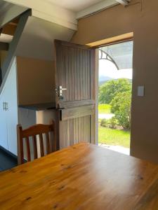 a wooden table in a kitchen with a large window at Wilderness Escape with breathtaking Views in Wildernis +15 photos