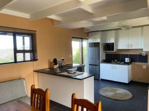 a kitchen with a table and a counter top at Wilderness Escape with breathtaking Views in Wildernis
