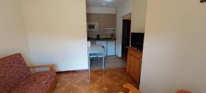a room with a kitchen with a couch and a table at APARTAMENTOS RURALES PERNÚS in Colunga