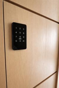 a close up of a door with a key board on it at Wink at Jalan Besar in Singapore