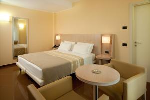 a hotel room with a bed and a table at Hotel Chiaraluna in Civitanova Marche +96 photos