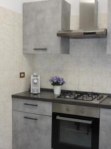 a kitchen with a stove and a sink at Rosario House in Comacchio