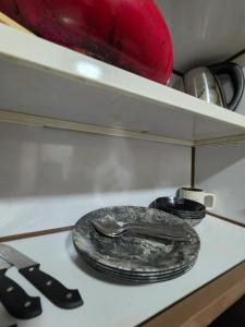 a plate and spoon sitting on top of a stove at Ajman Beach View AIO4OO7 in Ajman 