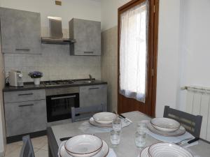 a kitchen with a table with plates on it at Rosario House in Comacchio