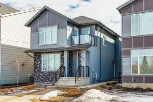 a house with a blue and gray exterior at Executive Basement suite in Edmonton