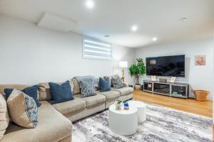 a living room with a couch and a tv at Executive Basement suite in Edmonton