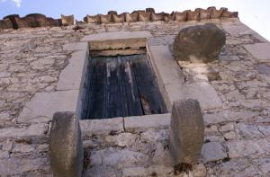 a stone building with a water fountain on it at Ilia House Altomira in Altomirá