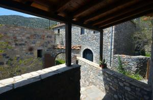 an outside view of a building with a stone wall at Ilia House Altomira in Altomirá