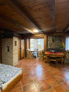 a room with a bed and a table and chairs at Studio JAVOR pod Tatrami in Jezersko